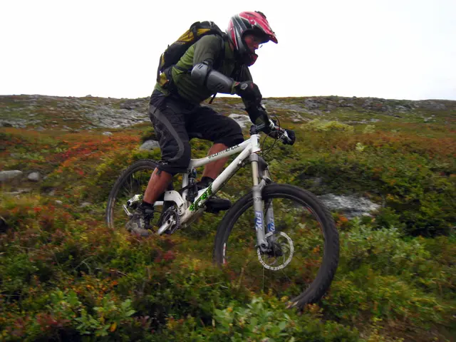 Speeding cyclist surpasses 60 kilometers per hour on the road.